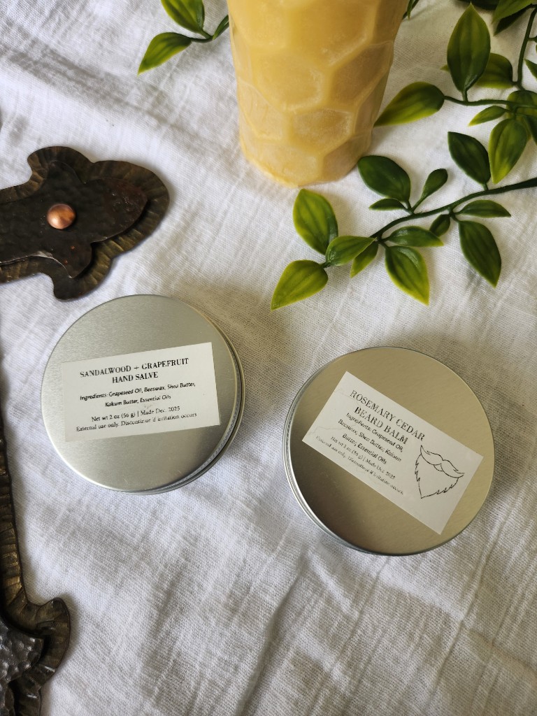 Hand salve and beard balm tins on linen