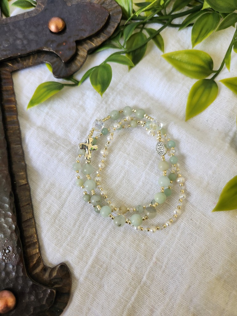 Stacked sage green rosary bracelet with cross and medal charms